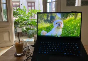 A view of my laptop and an oat latte in front of the balcony at Lá Studio in Hanoi