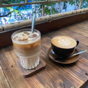 Two coffees on a balcony at The Little Plan Cafe - one of the best coffee shops in Hanoi