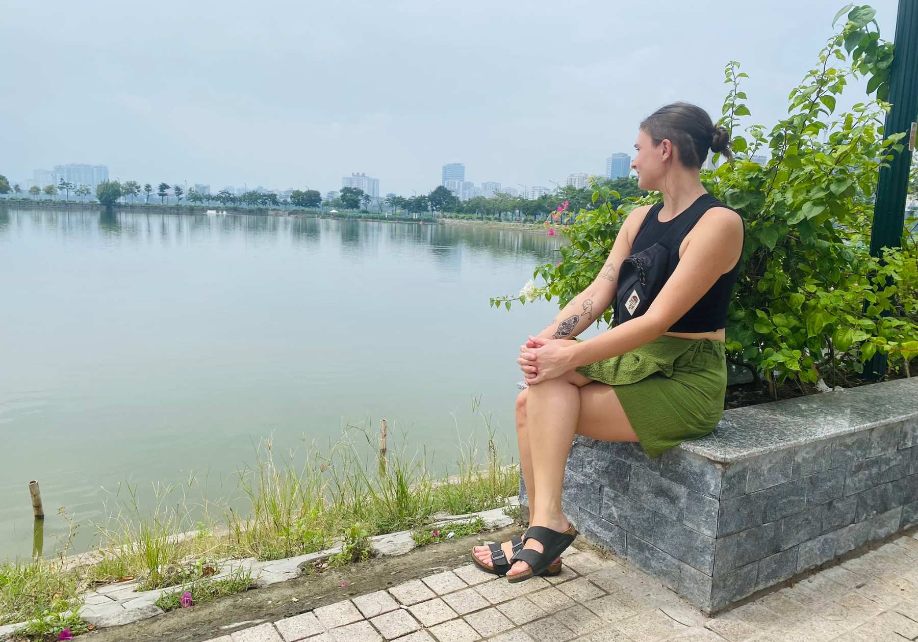 Lucy sat by a lake in Hanoi one of the top things to do in Hanoi